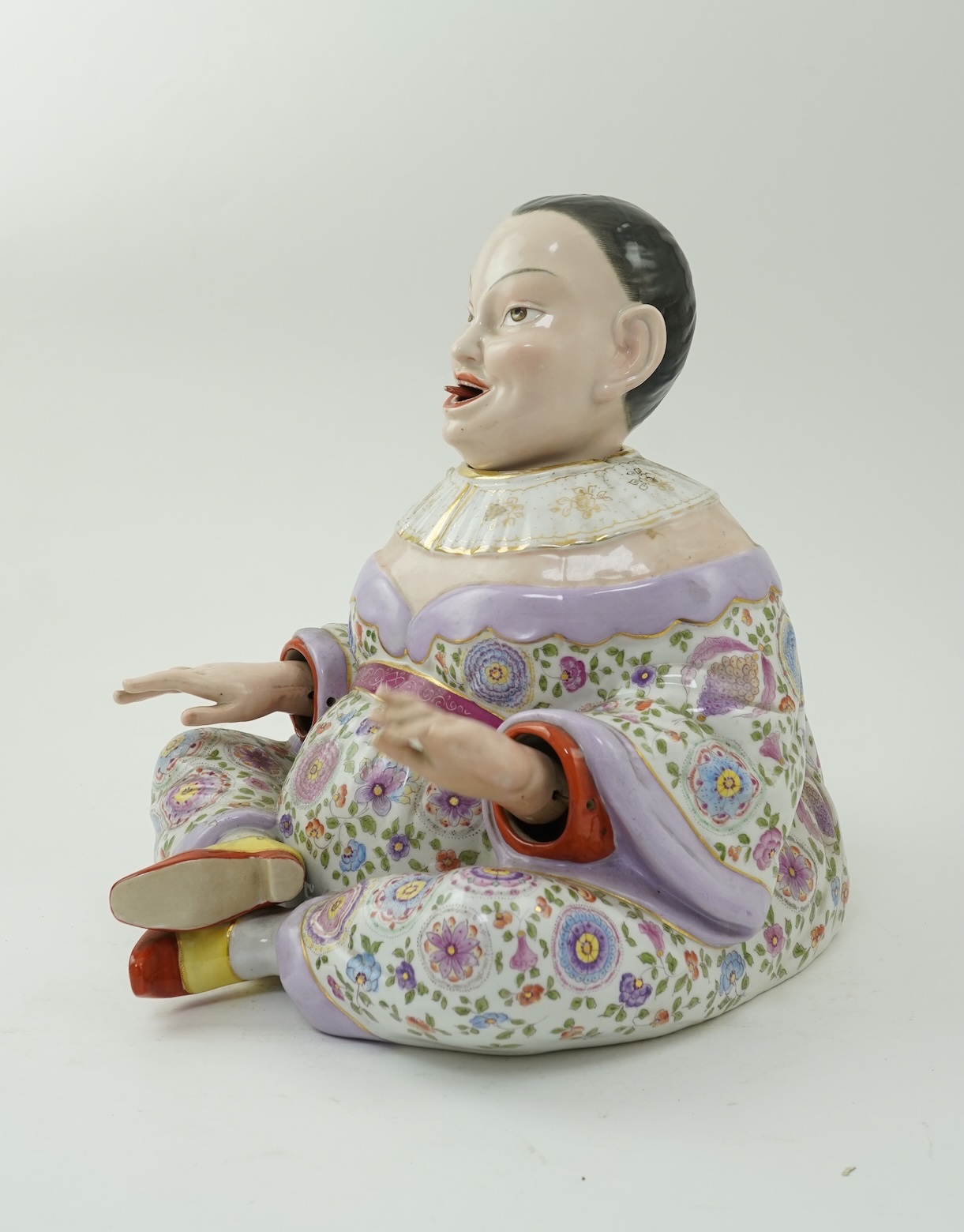 A large Continental porcelain figure of a seated nodding Buddha, early 20th century